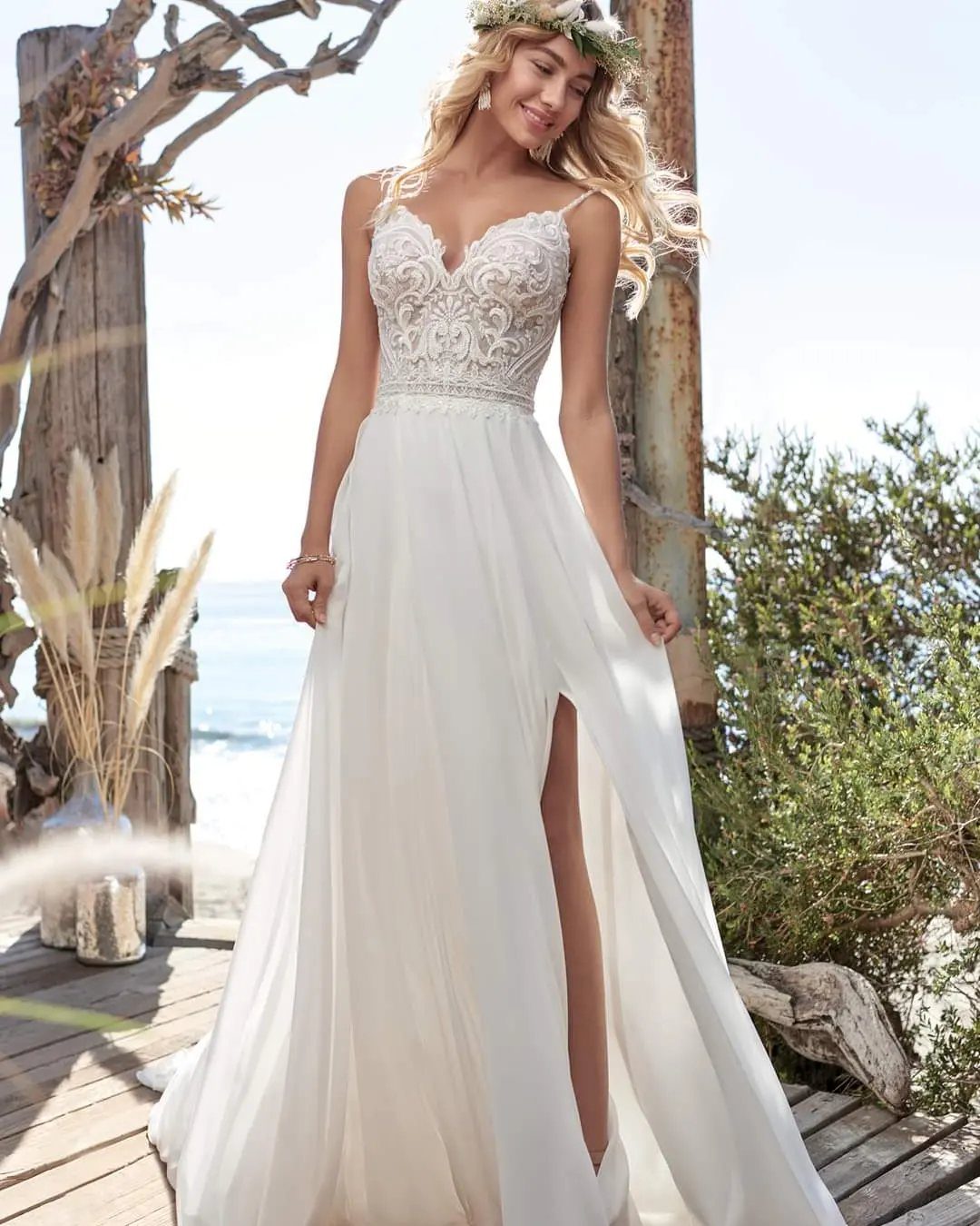 Woman in a white chiffon wedding dress with lace bodice and flower crown