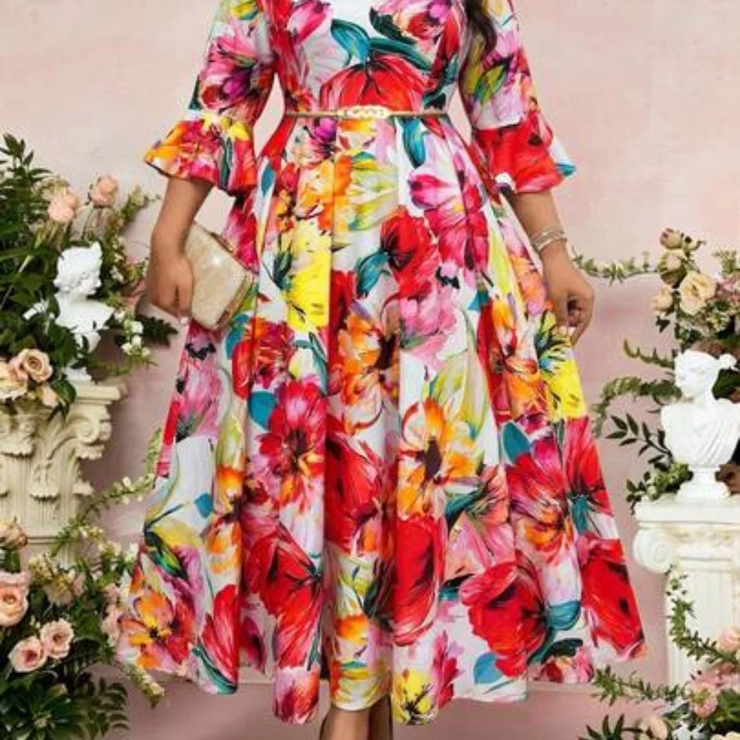 Floral print maxi dress with long sleeves and a gold belt among white flowers