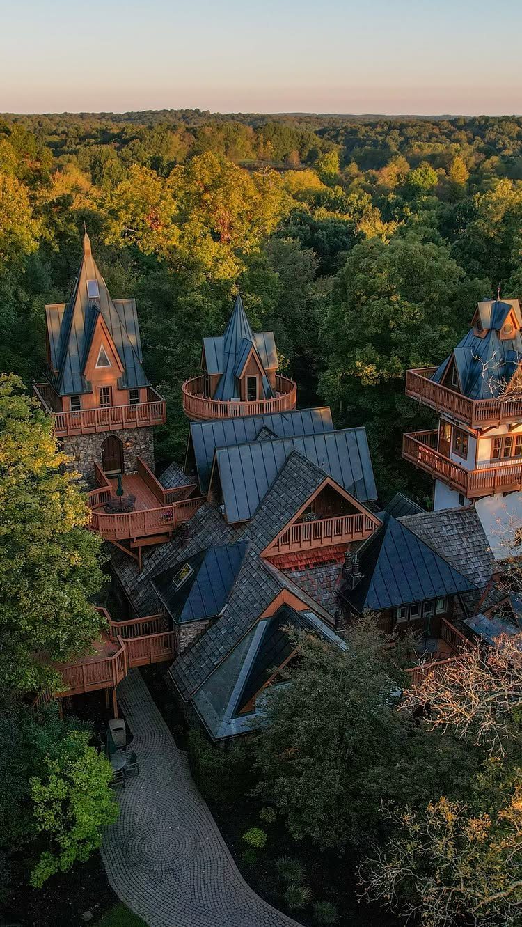 Landoll's Mohican Castle resort with grey pointed roofs surrounded by dense green forest