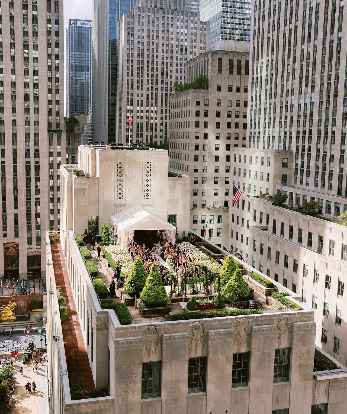 Rooftop terrace wedding with white tent and greenery surrounded by city skyscrapers