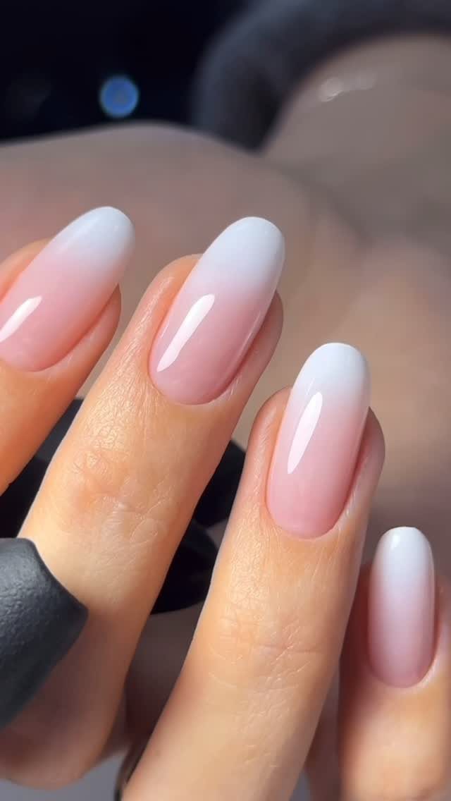 Almond-shaped nails with a soft pink and white ombré French manicure finish.