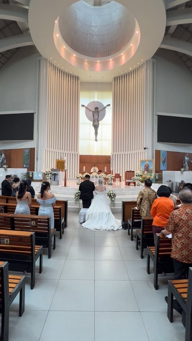 Bride and groom standing at the altar during a Catholic wedding mass in church