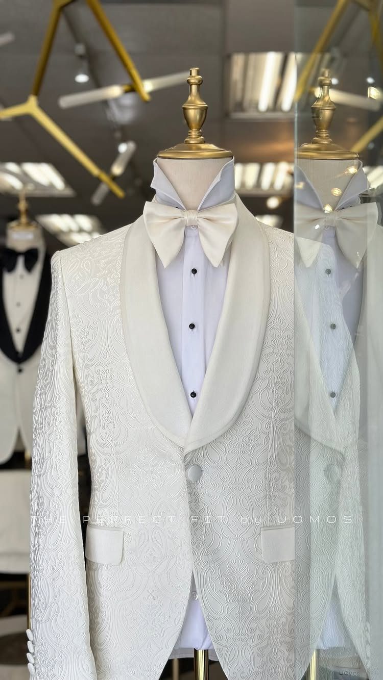 White textured tuxedo jacket with shawl lapel and bow tie on a mannequin.