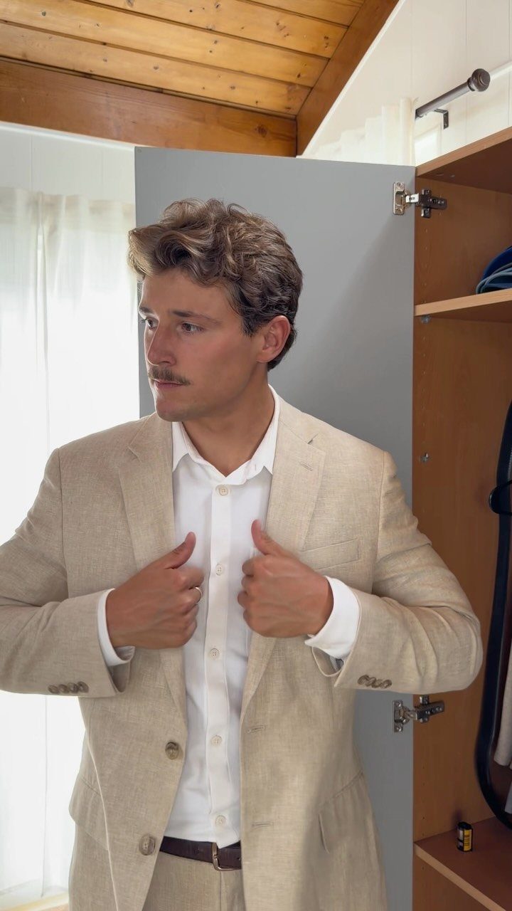 Man wearing a light beige linen suit and white shirt for a summer wedding