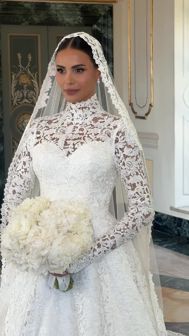 Bride in a lace wedding dress wearing a traditional lace mantilla veil