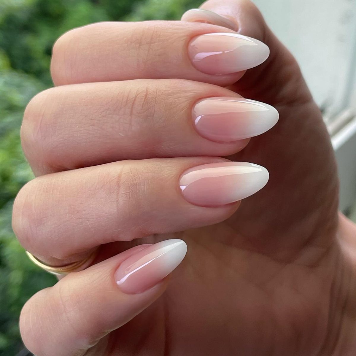 Almond shaped nails with a soft pink to white ombre baby boomer effect.