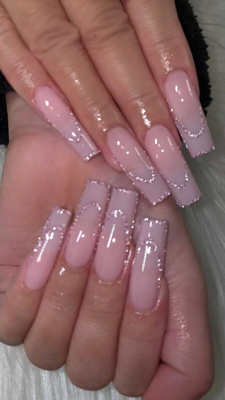 Long square pink nails with silver glitter curved accents on the tips.