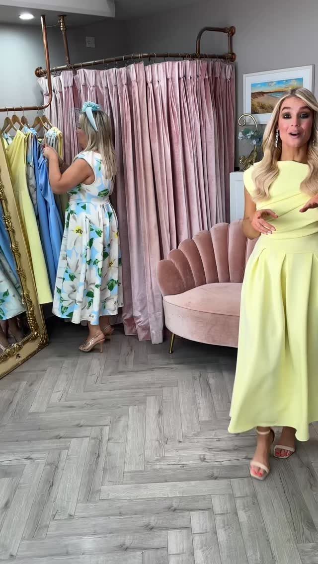 Woman wearing a long butter yellow dress standing in a boutique setting.