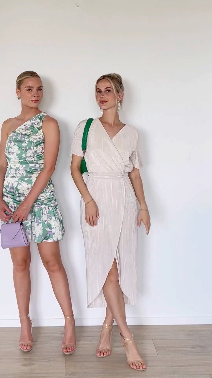 Woman in a beige midi wrap dress with short sleeves and gold heels.