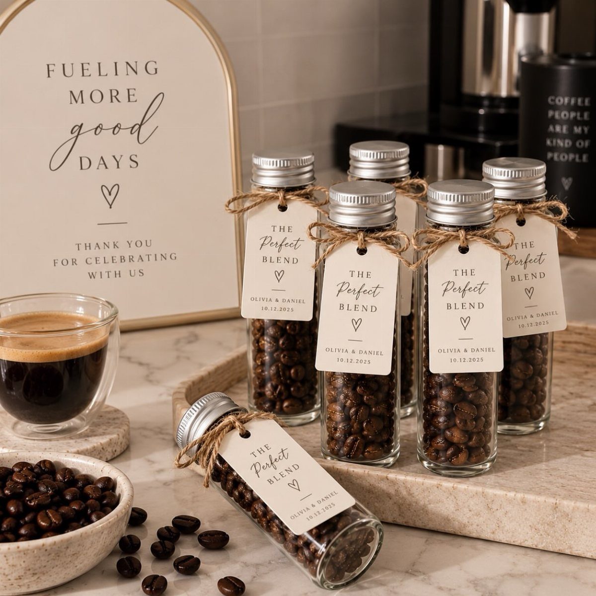 Glass jars of coffee beans with personalized wedding tags on a marble countertop.