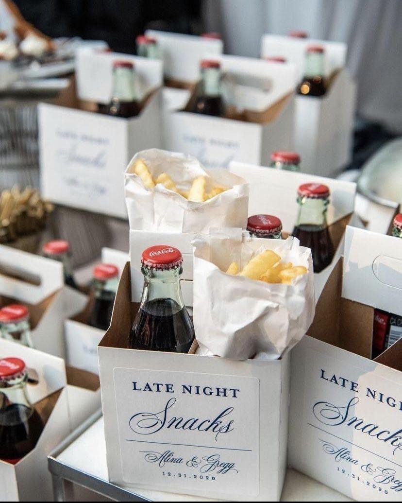 White snack boxes with Coca-Cola bottles and french fries for late night wedding treats