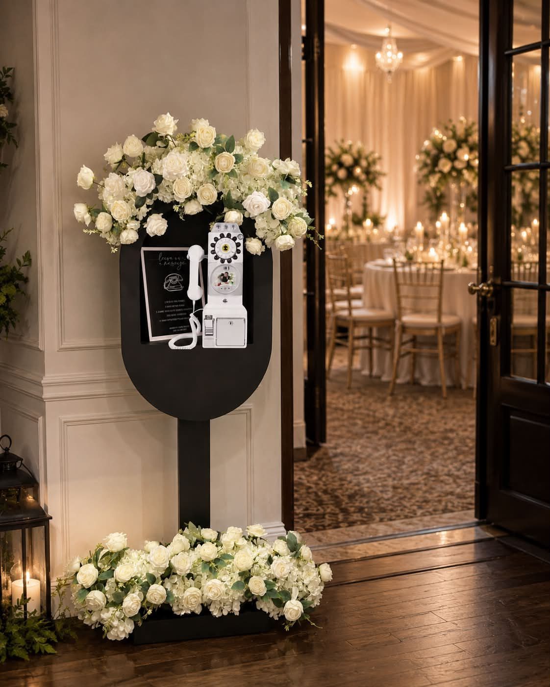 Vintage white rotary telephone on a black floral stand for wedding audio guest book