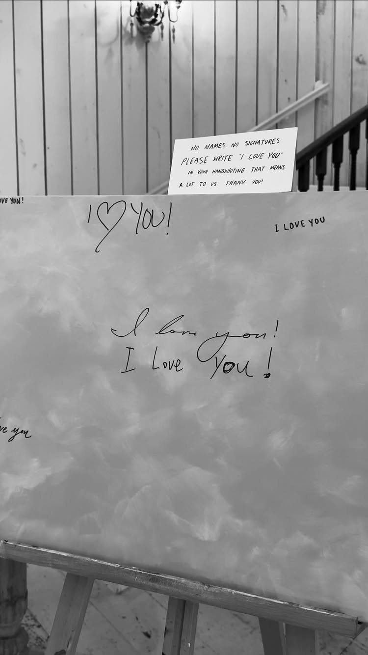 Large canvas on an easel with handwritten I love you messages in black ink.