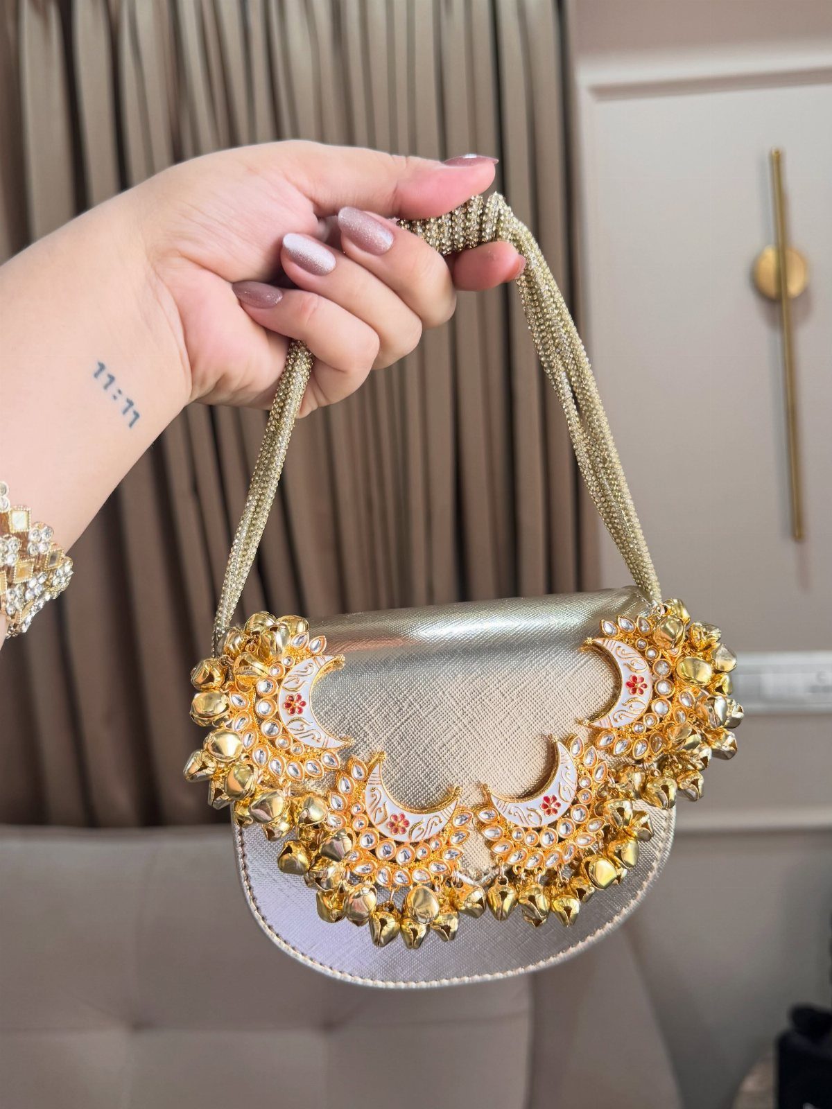 Gold metallic petite bag with intricate beadwork and a braided shoulder strap.