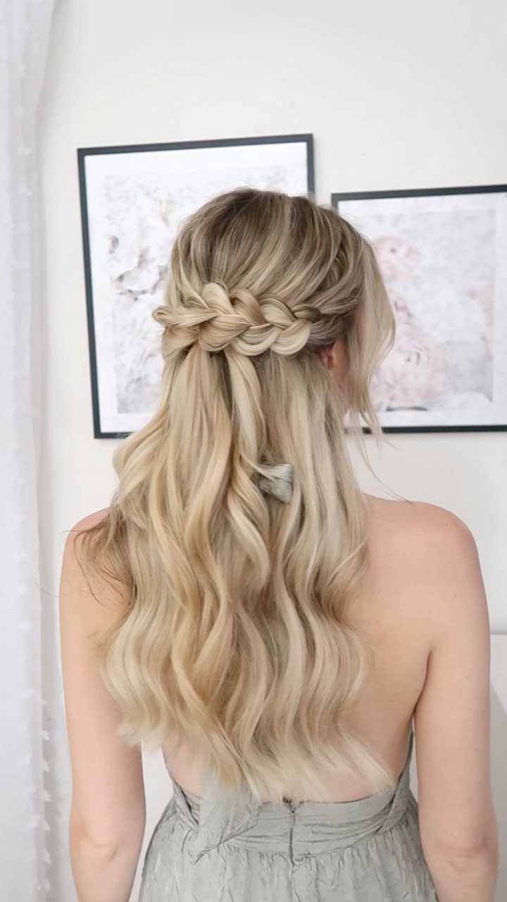 Blonde wavy hair styled in a half-up half-down look with a horizontal braid.