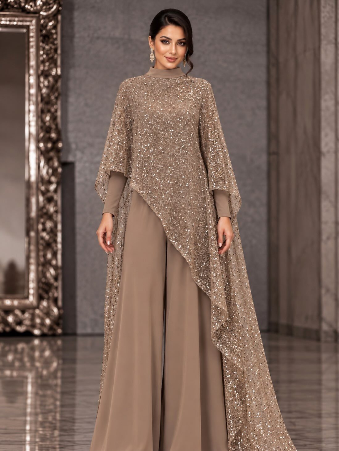 Woman in a taupe wide-leg jumpsuit with a shimmering sequined cape overlay.