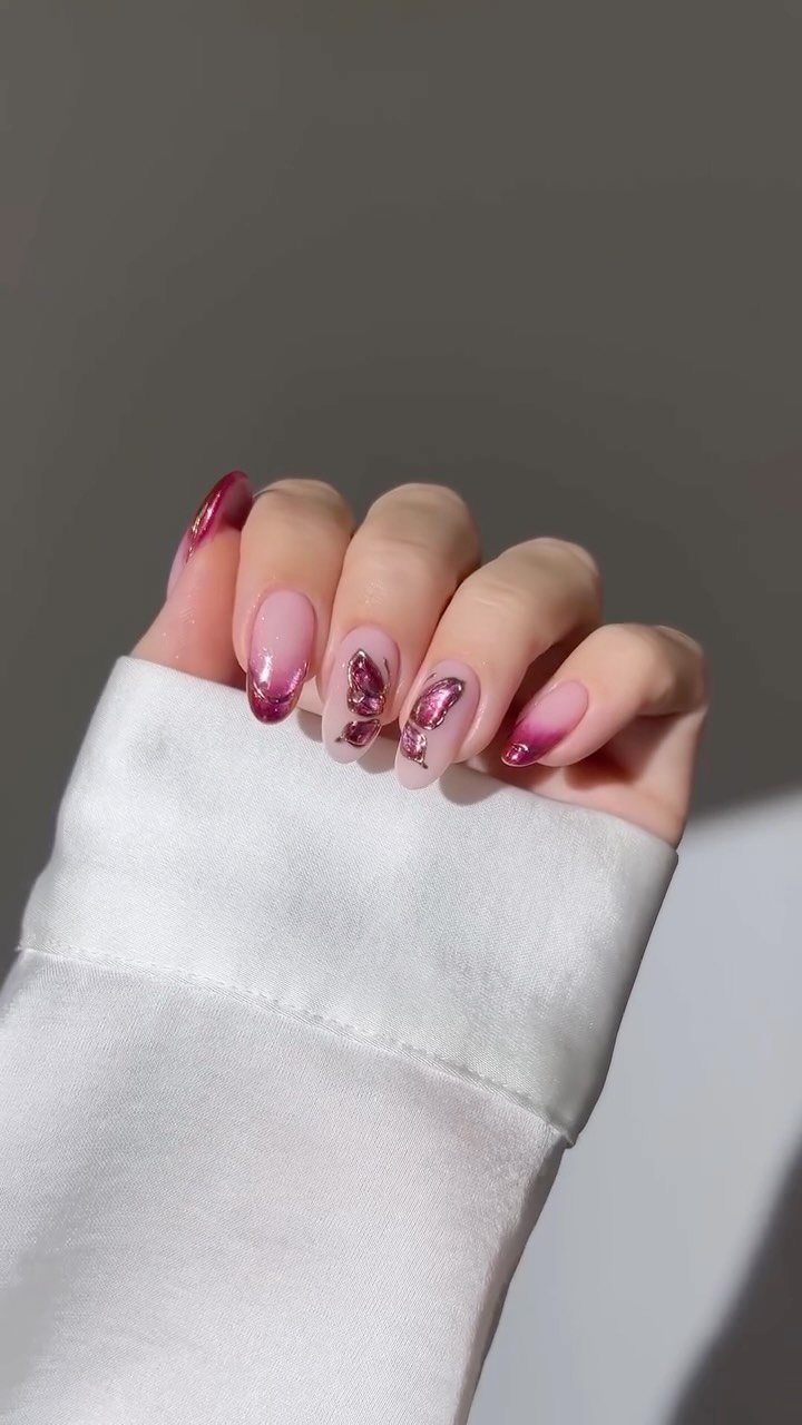 Almond-shaped nails with nude base and shimmering pink ombre glitter tips.