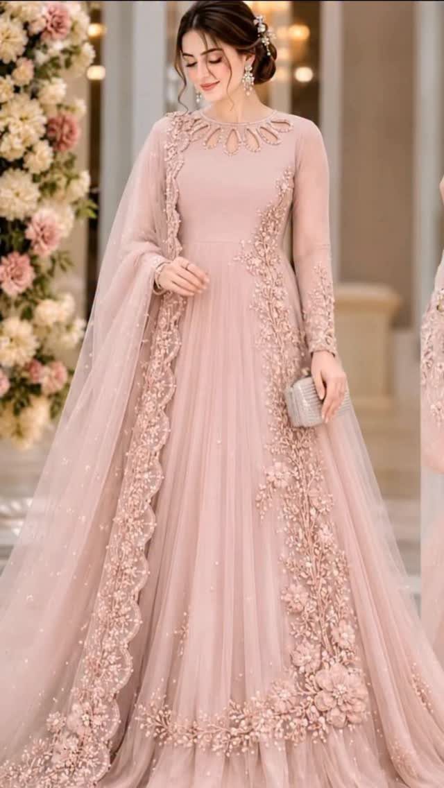 Woman in a blush pink embroidered gown with a matching cape and silver clutch.