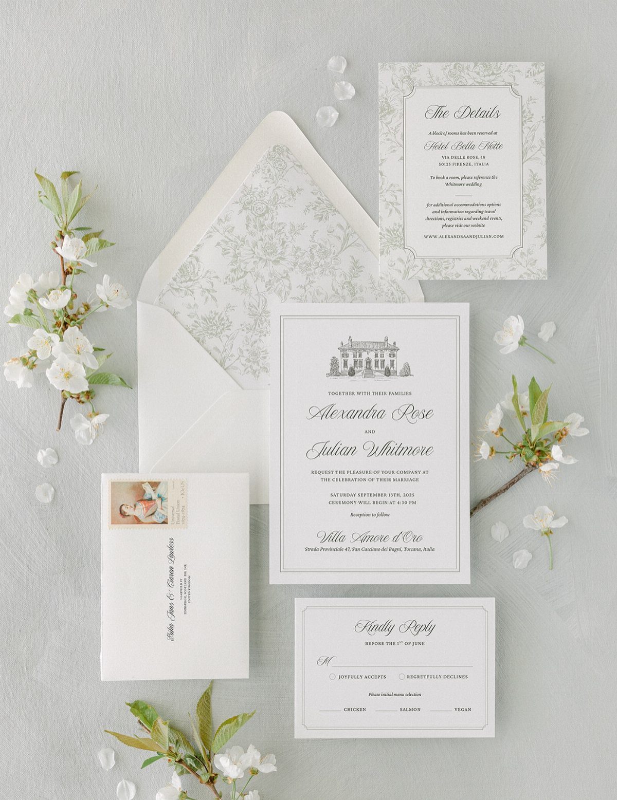 Wedding invitation kit with matching cards and floral lined envelope and white blossoms.