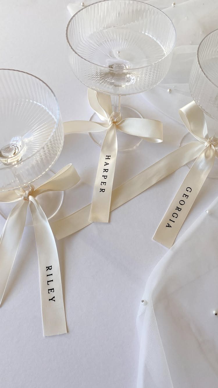 Ribbon place cards with names tied around the stems of ribbed glass coupes.
