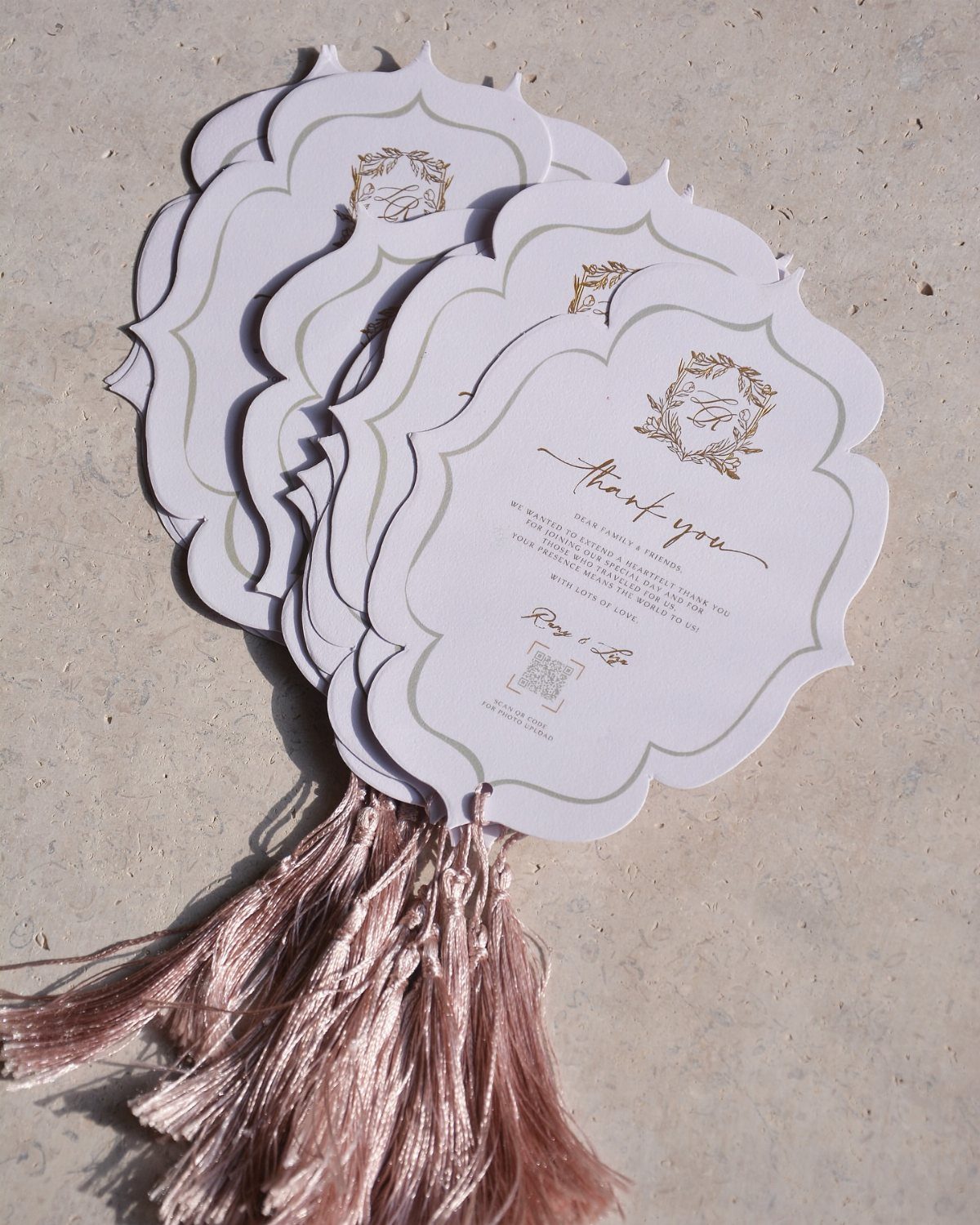 White scalloped thank you cards with gold foil details and a rose-gold tassel.