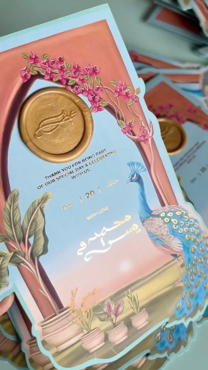 Wedding thank you cards with a gold wax seal and blue peacock illustration.