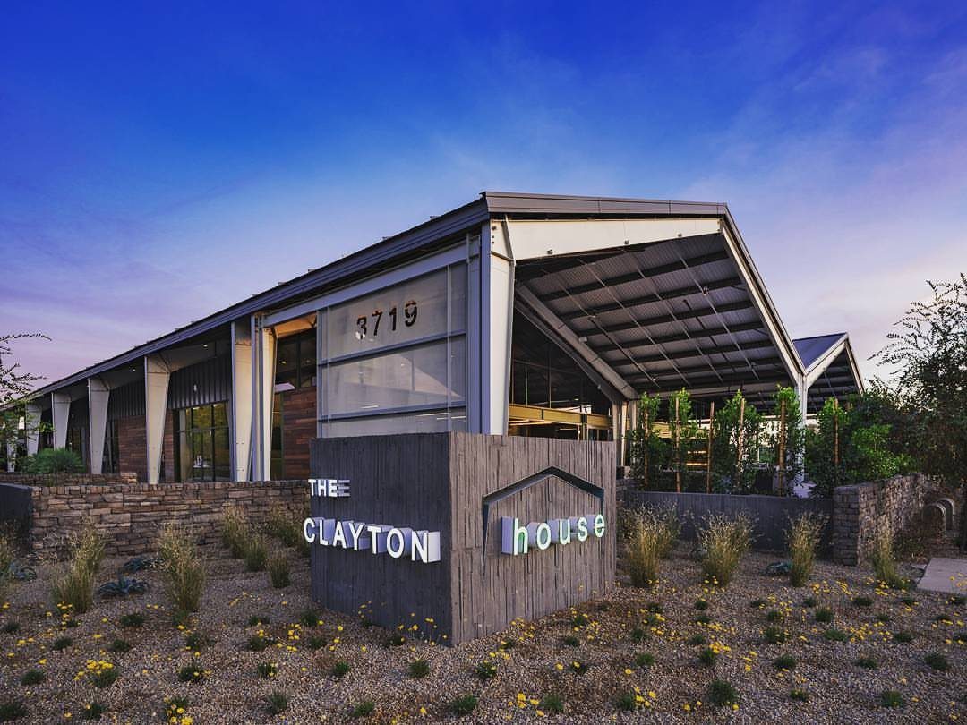 The Clayton House venue building with a modern industrial design and desert landscaping.
