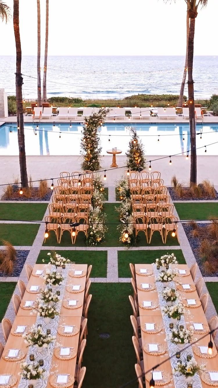 Outdoor wedding ceremony and reception setup overlooking a swimming pool and the ocean.