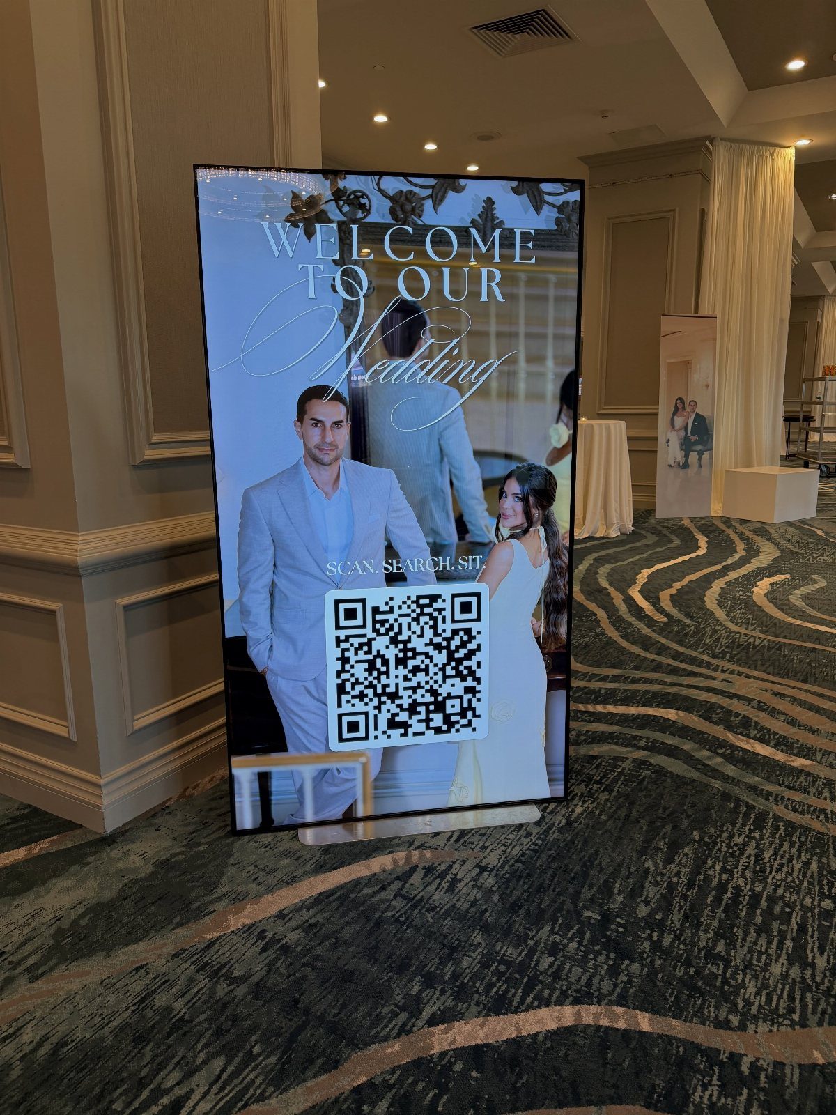 Wedding welcome sign with a couple's photo and a large QR code for guests.