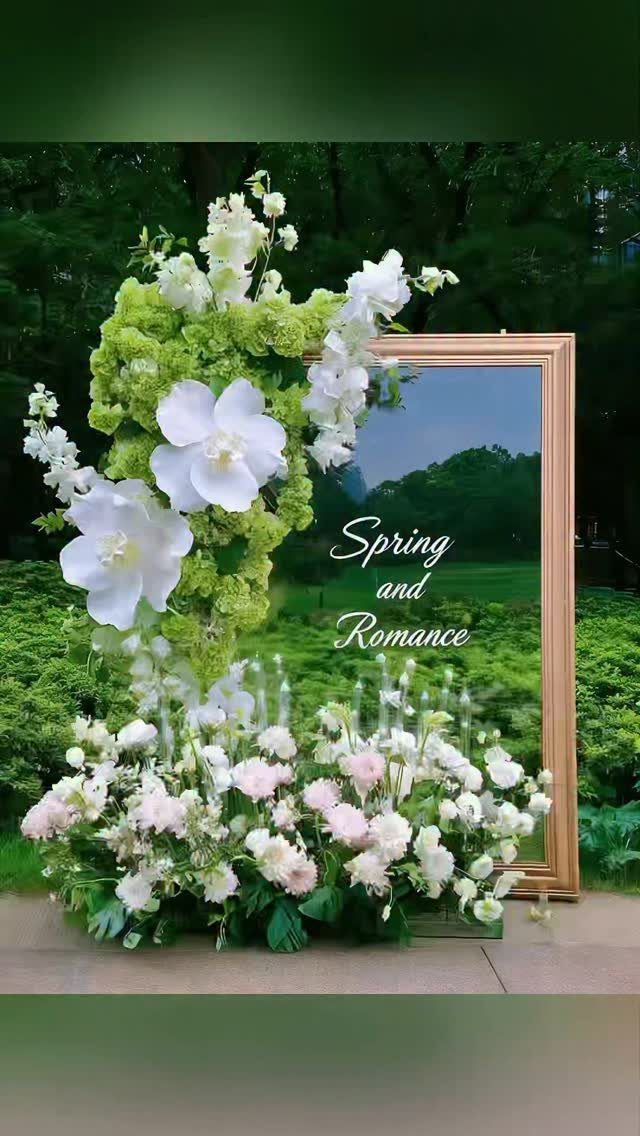 Gold framed mirror with Spring and Romance text surrounded by white and pink flowers